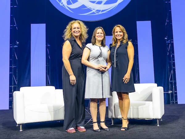 Candace Heron (middle) receives the RIMS Volunteer of the Year Award at RISKWORLD 2026.